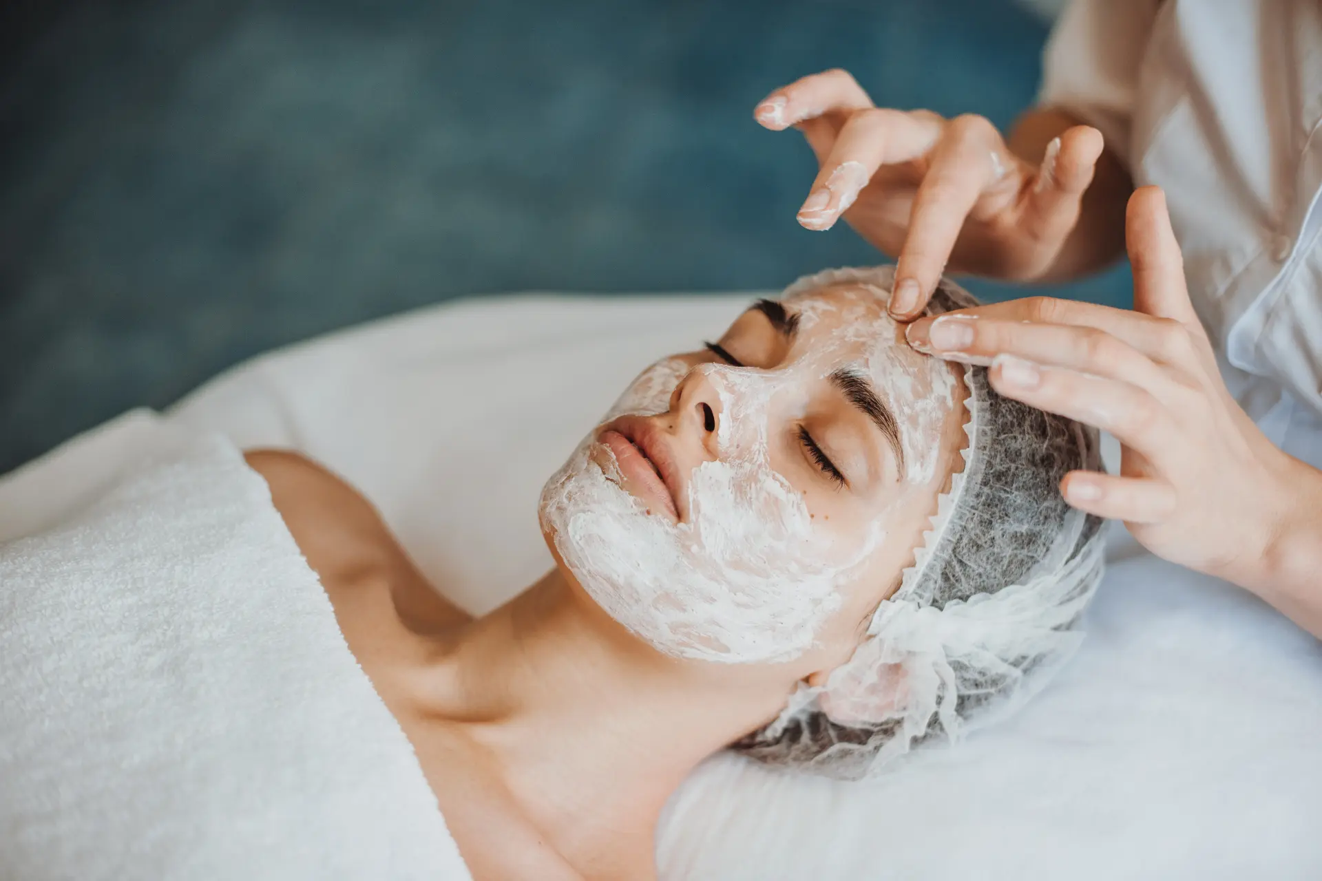 Esthetician applying a facial treatment to a client