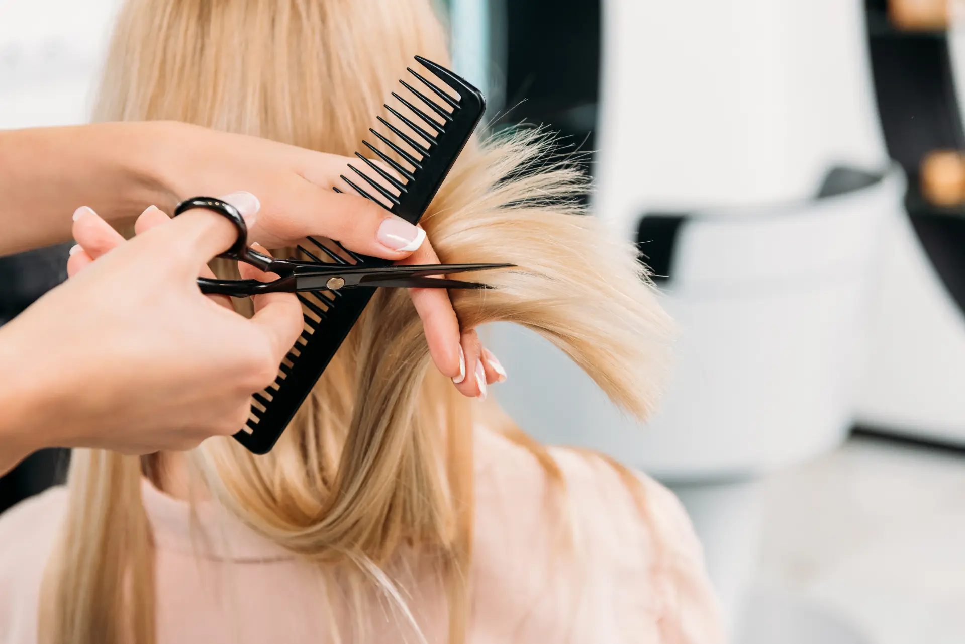 Hair stylist cutting a client's hair in a salon