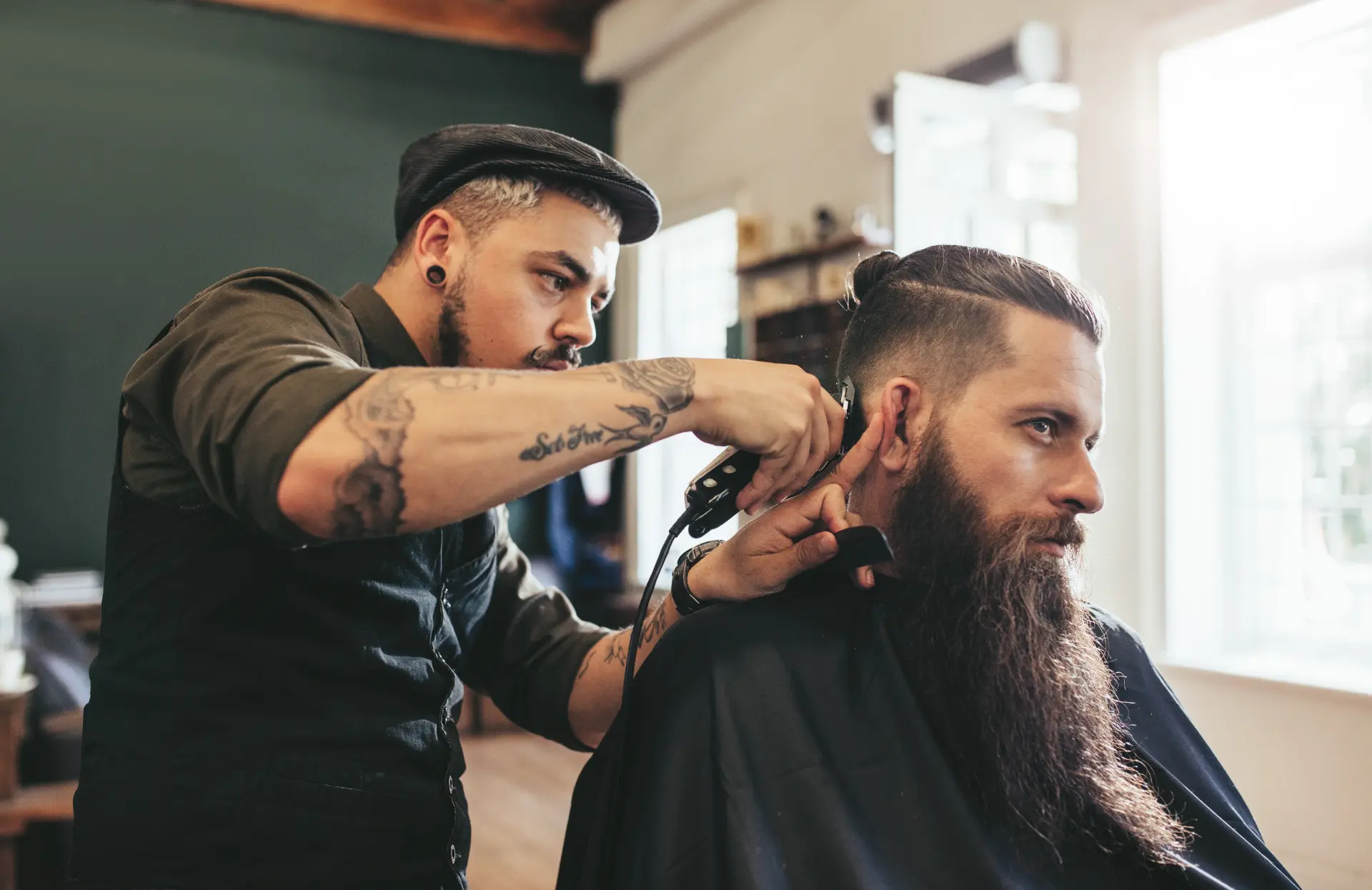 Barber trimming a client's hair in a professional barbershop